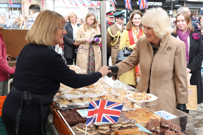 Queen Camilla meets a trader during a visit to the Farmers' Market in The Square, Shrewsbury, in Shropshire.
