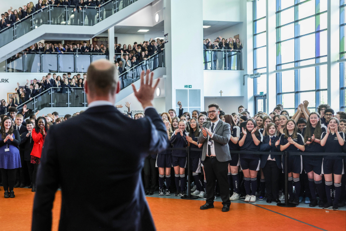 The Prince of Wales waves to students at St Michael's CE High School